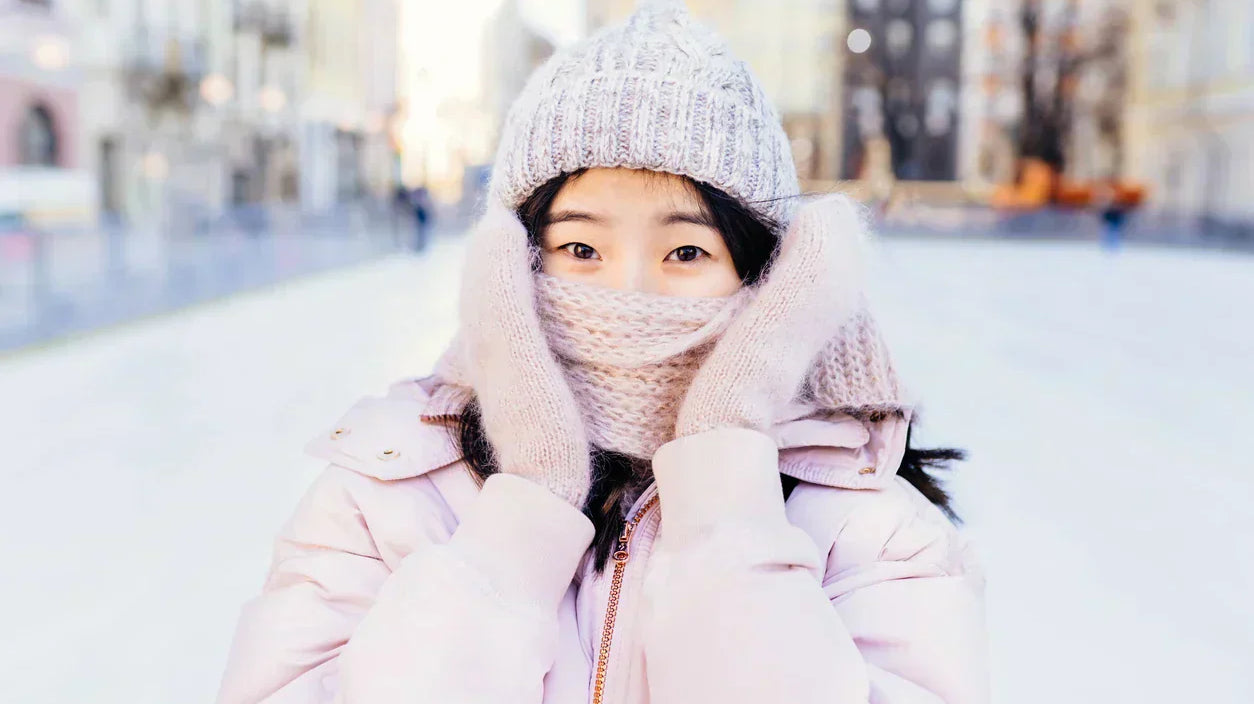 Woman outdoors in winter with scarf covering face - winter dry eyes guide