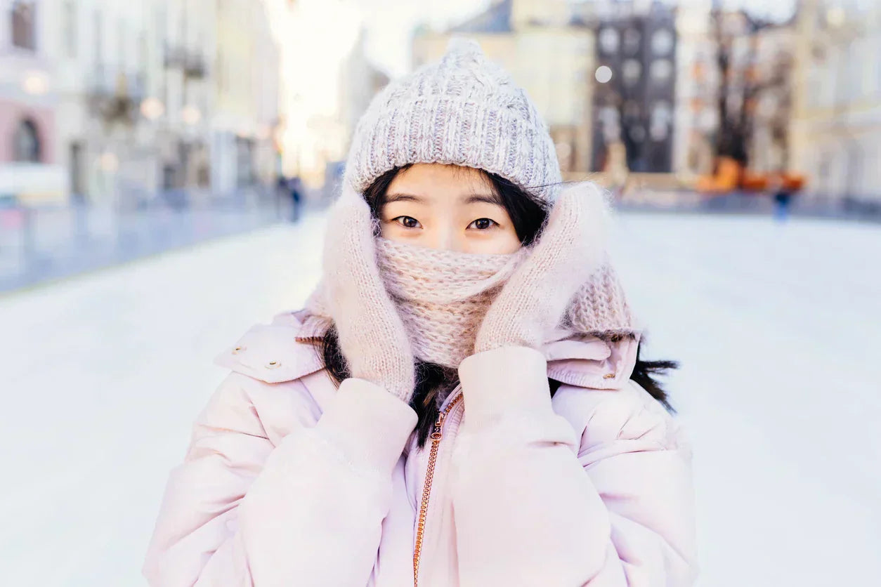 Woman outdoors in winter with scarf covering face - winter dry eyes guide
