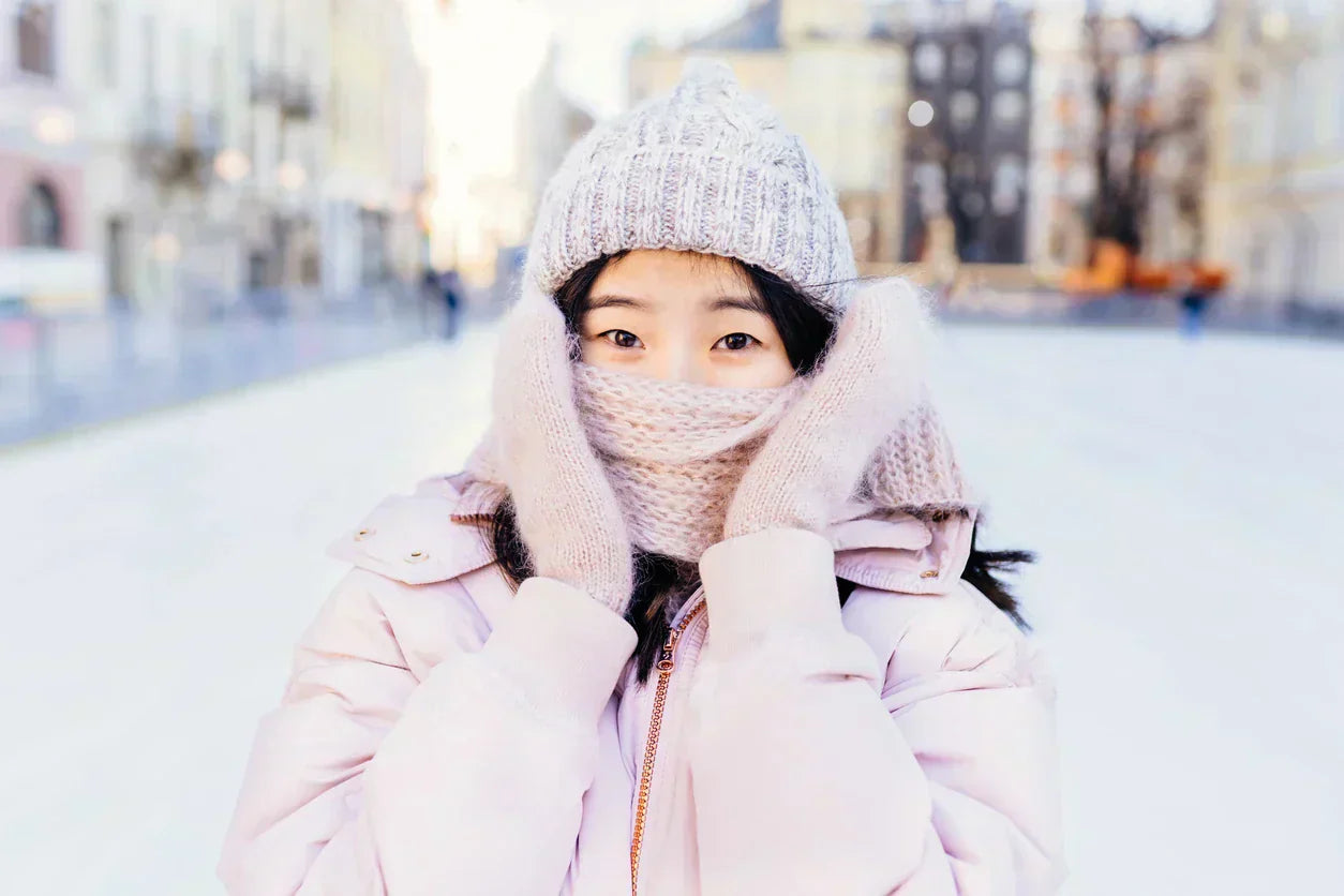 Woman outdoors in winter with scarf covering face - winter dry eyes guide