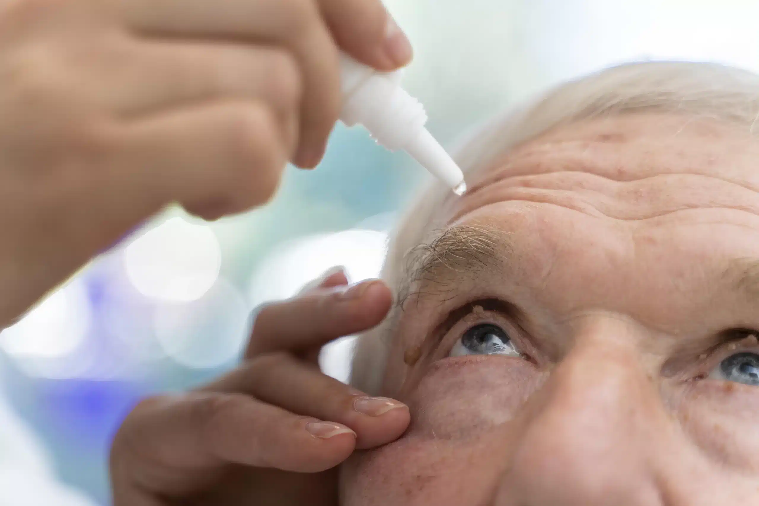 Doctor pouring some eye drops